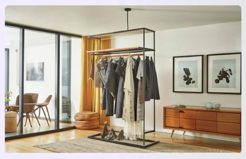 A freestanding clothing rack used as a room divider