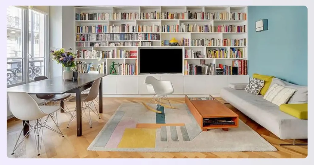 A multi-functional living room with a large bookshelf