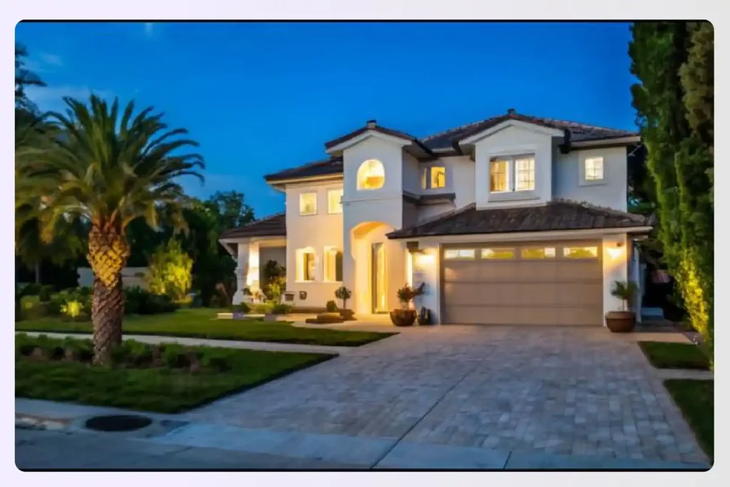 A beautifully lit modern home at dusk with outdoor lighting