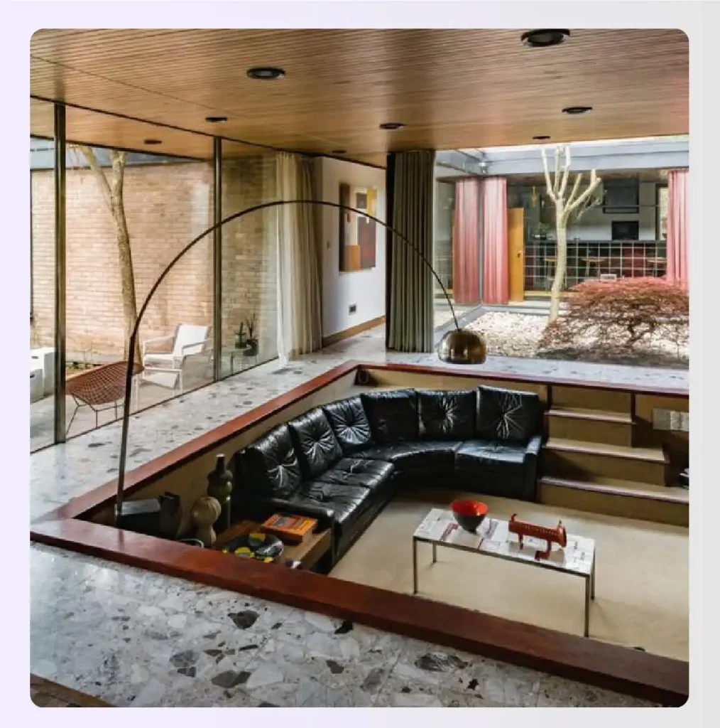 A cozy sunken conversation pit with cushions