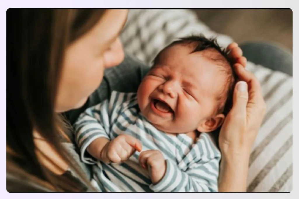 A mother holding her crying baby gently