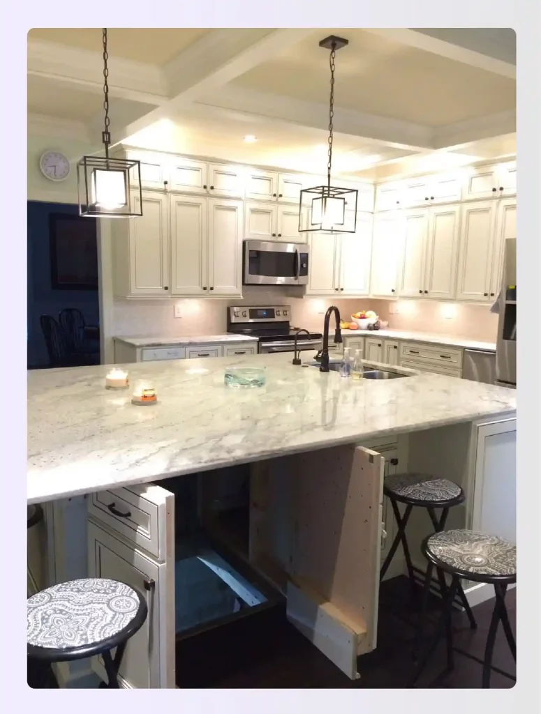 A white kitchen island with a hidden trapdoor in the floor
