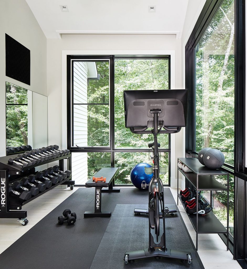 Gym room with Peloton bike, weights, and workout equipment.