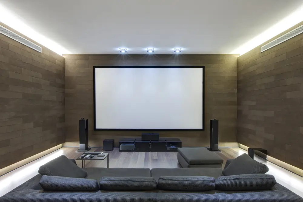 Home theater room with a large projection screen and comfortable seating.