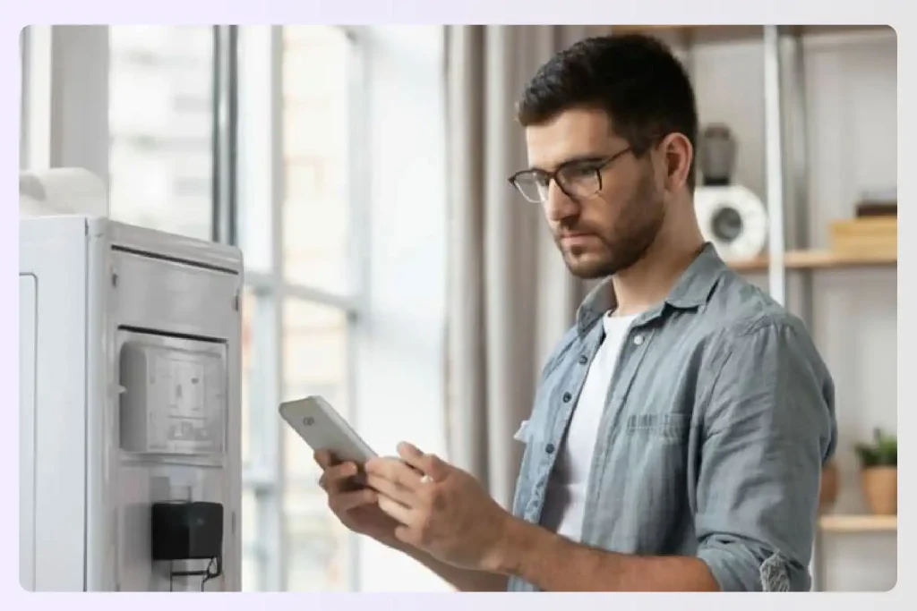 Man checking an HVAC unit with his smartphone