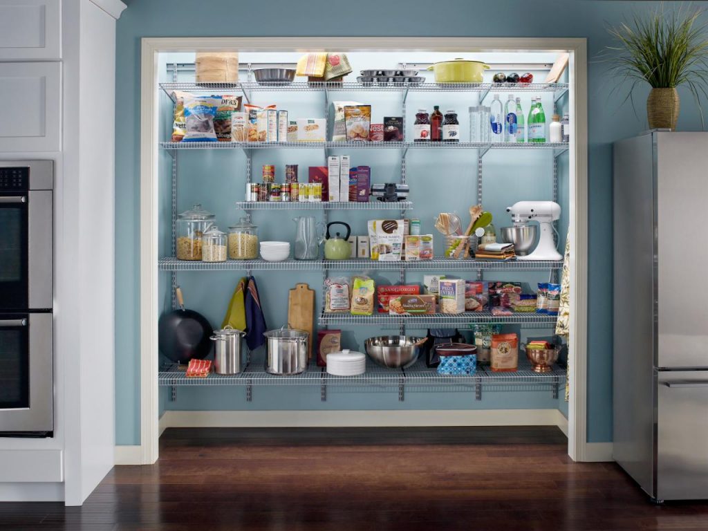 A well-organized pantry with wire shelving units filled with various food items, cookware, and kitchen tools.
