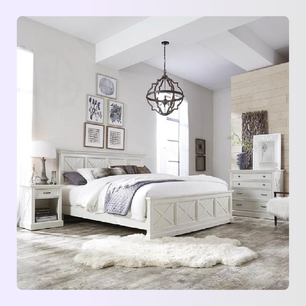 White distressed wood bedroom set in a bright room White distressed wood bedroom set in a bright room