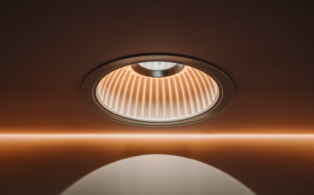 Close-up of a baffle recessed light fixture in a ceiling.