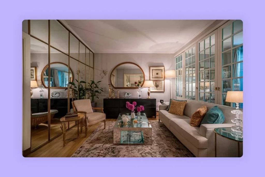 A bright living room furnished with a sofa, armchair, coffee table, and wall mirrors.