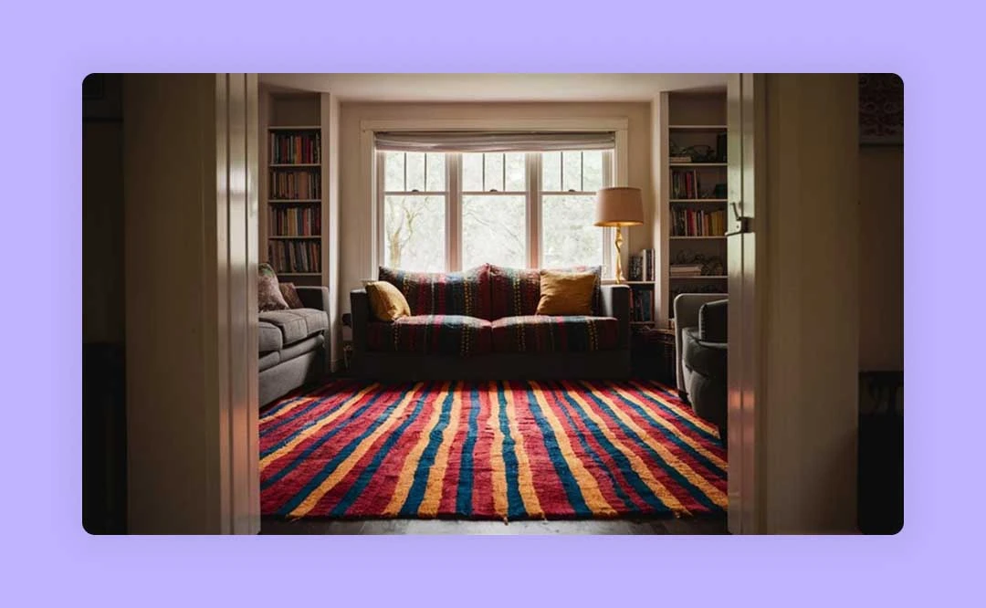 A colorful living room with a couch and a rug.
