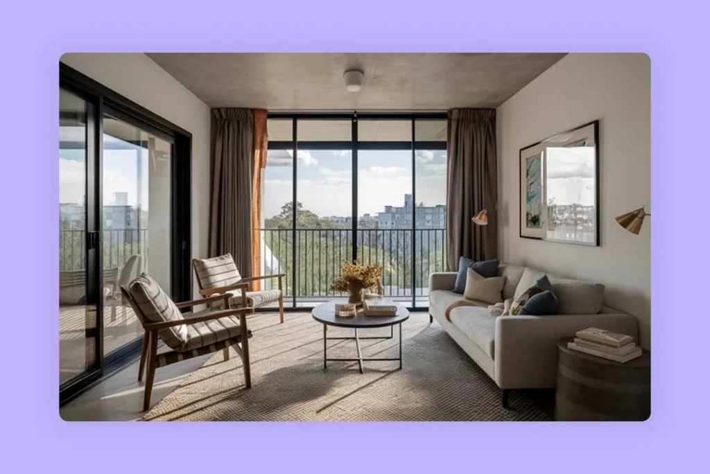 Large sliding glass doors open to a balcony, bringing the outdoors in