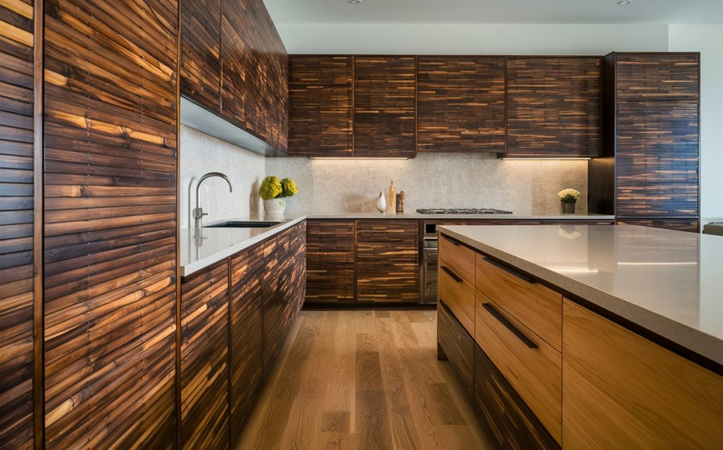 A clean kitchen with warm-toned wooden cabinets and a stainless steel sink