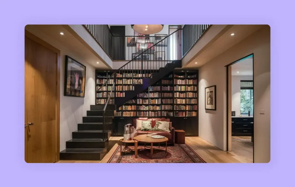 A creative space-saving staircase idea featuring a large built-in home library 