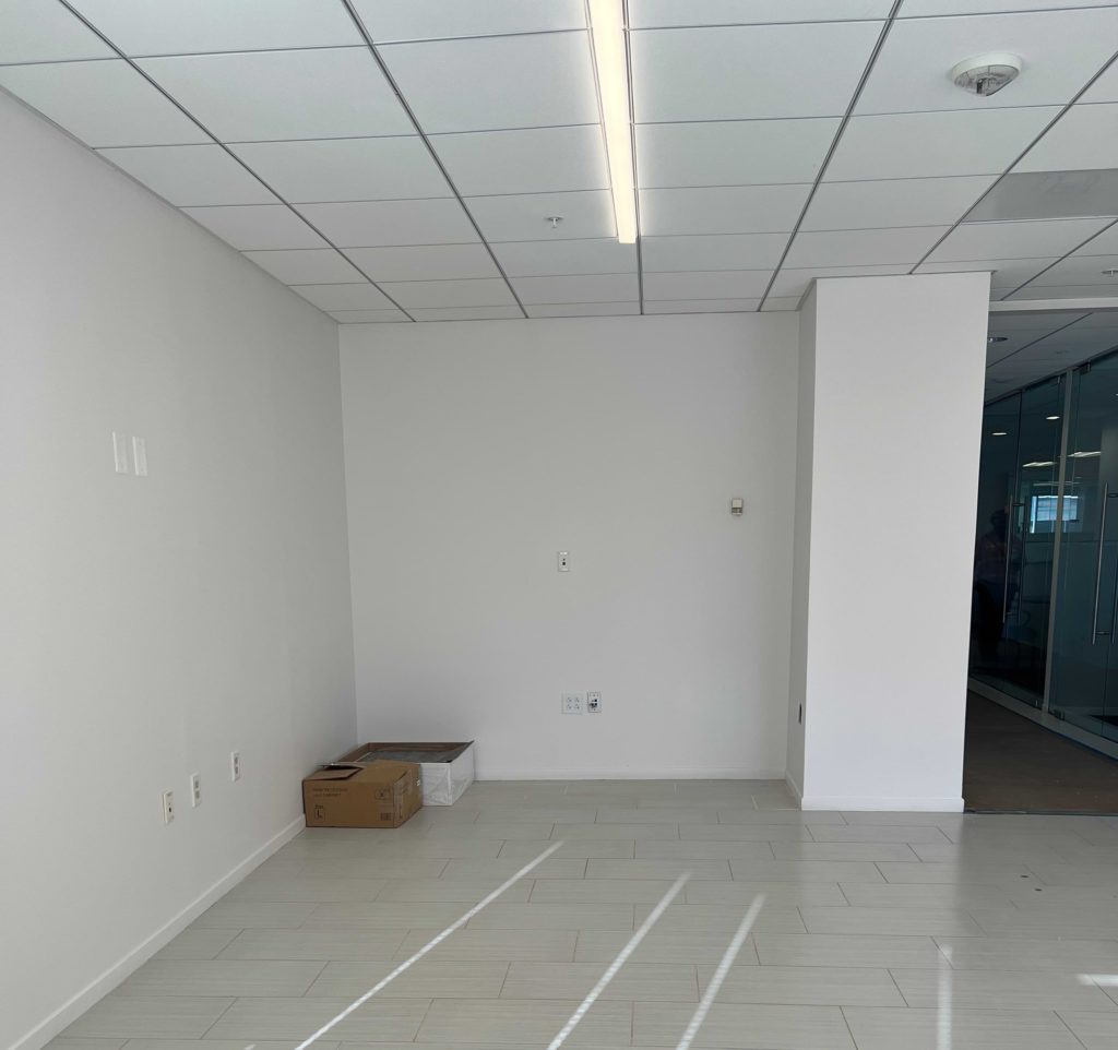 Before transformation: traditional office space with a rigid layout and minimal collaborative areas