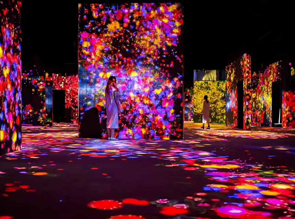 Immersive digital art installation at TeamLab Borderless Tokyo, featuring vibrant projection mapping and interactive light displays.