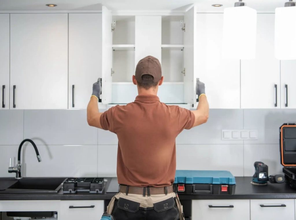 a man showing how to install kitchen