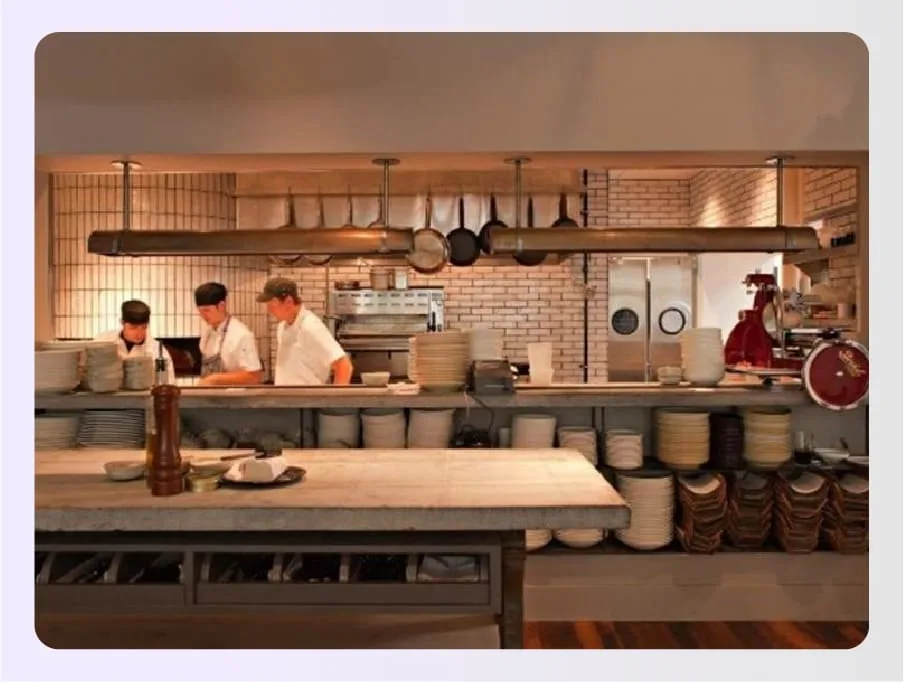 Chefs cooking in open kitchen visible to diners Chefs cooking in open kitchen visible to diners