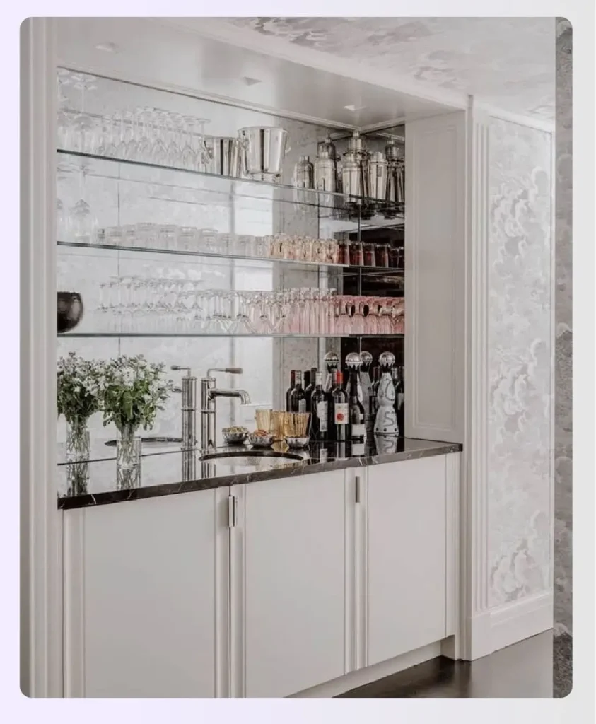 A mirrored backsplash behind shelves of liquor bottles A mirrored backsplash behind shelves of liquor bottles