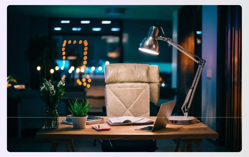 A modern desk lamp illuminating a home office at night