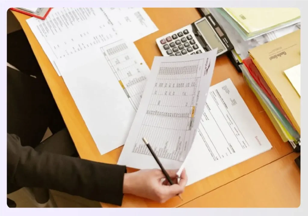 Designer reviewing financial documents for a loan Designer reviewing financial documents for a loan