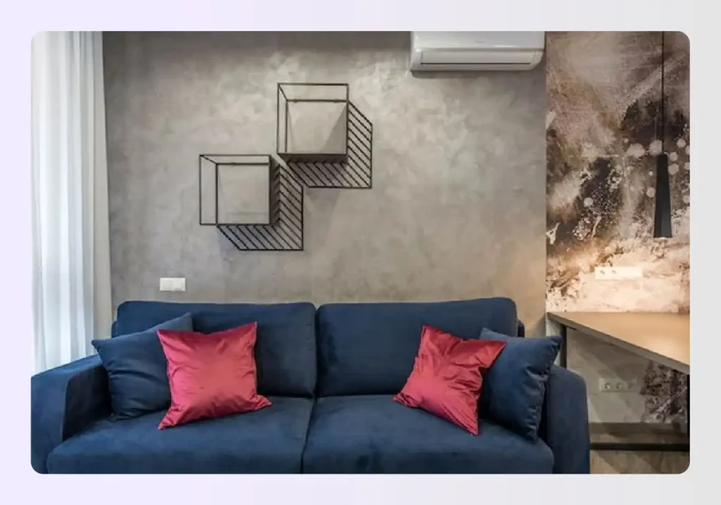 Modern blue sofa against textured wall Modern blue sofa against textured wall