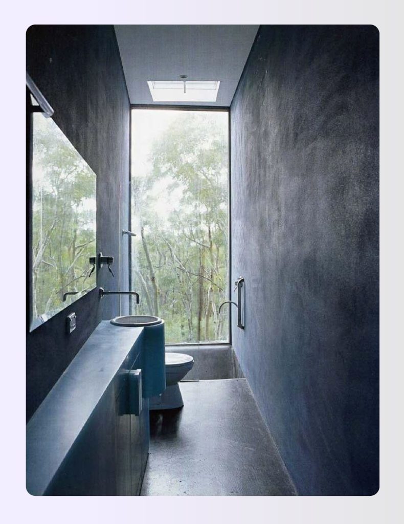 Narrow bathroom with a far-end window drawing light down the full corridor Narrow bathroom with a far-end window drawing light down the full corridor