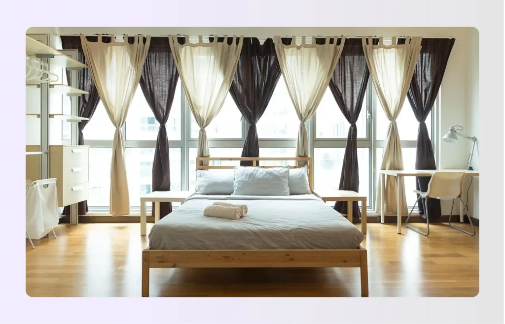 Bed centered in a large bedroom with open floor space on all four sides Bed centered in a large bedroom with open floor space on all four sides