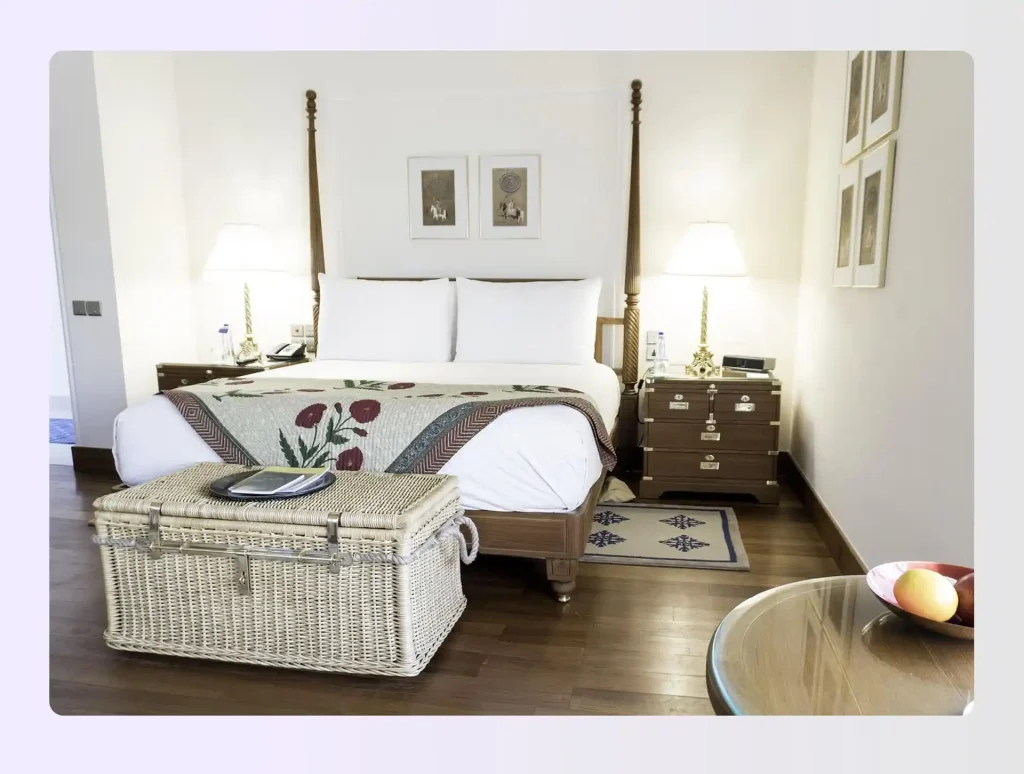 Narrow bedroom with bed on short wall and upholstered bench at the foot