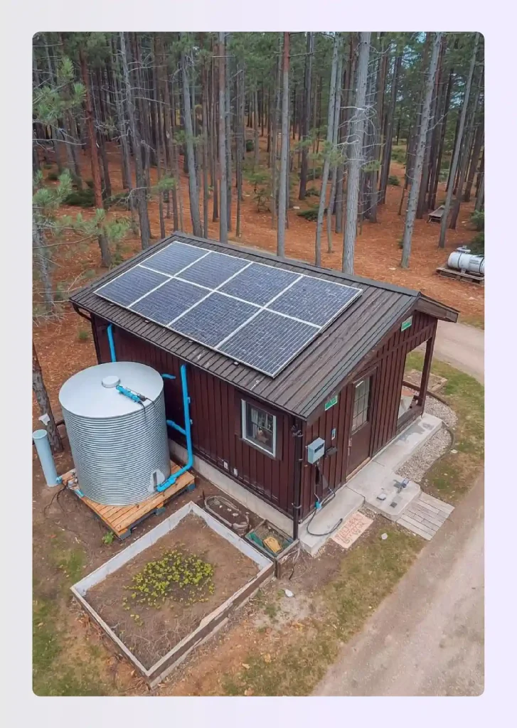 Off-grid utility cabin, small house with integrated solar and water systems Off-grid utility cabin, small house with integrated solar and water systems